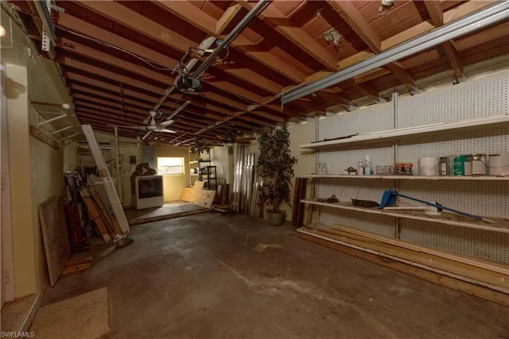 Below grade area with washer / clothes dryer and a workshop area