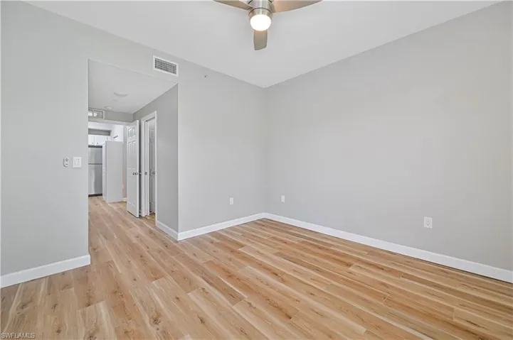 Unfurnished room featuring ceiling fan and light hardwood / wood-style flooring