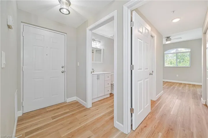 Foyer entrance featuring light hardwood / wood-style flooring, sink, and ceiling fan