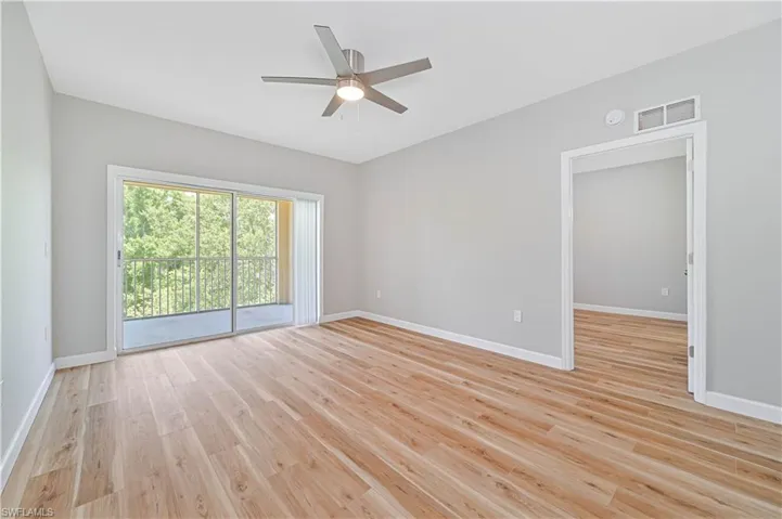 Empty room featuring ceiling fan and light hardwood / wood-style floors