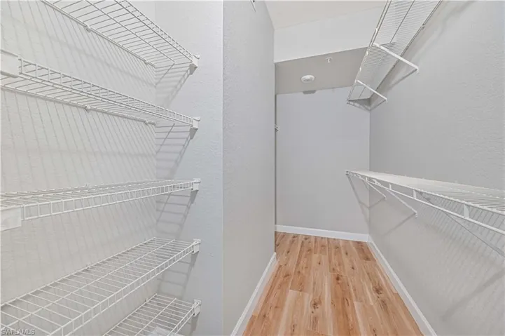 Spacious closet featuring light hardwood / wood-style floors