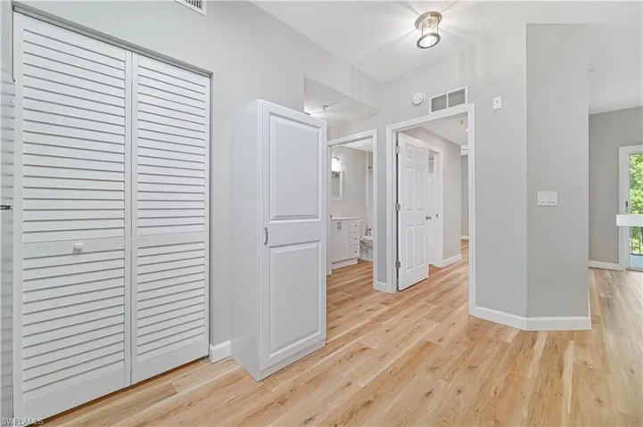 Hall featuring light wood-type flooring