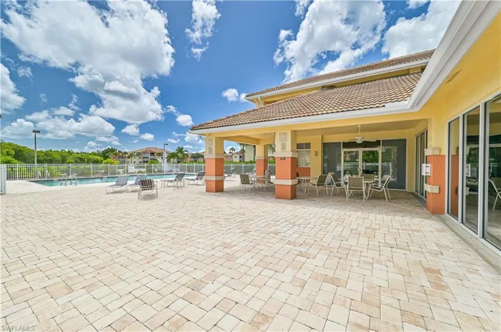 View of patio / terrace with ceiling fan and a community pool
