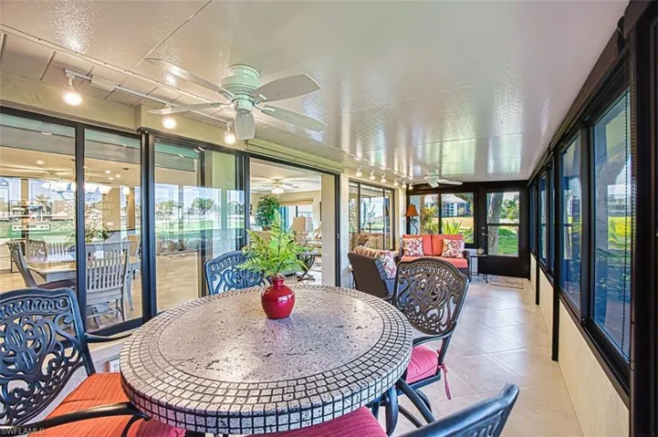 Sunroom with a ceiling fan, outdoor lounge area, and plenty of natural light