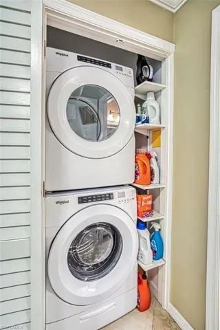 Laundry area featuring stacked washing machine and dryer