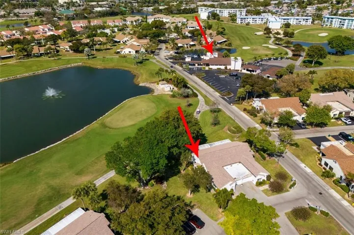 View of property location with a golf club and nearby suburban area