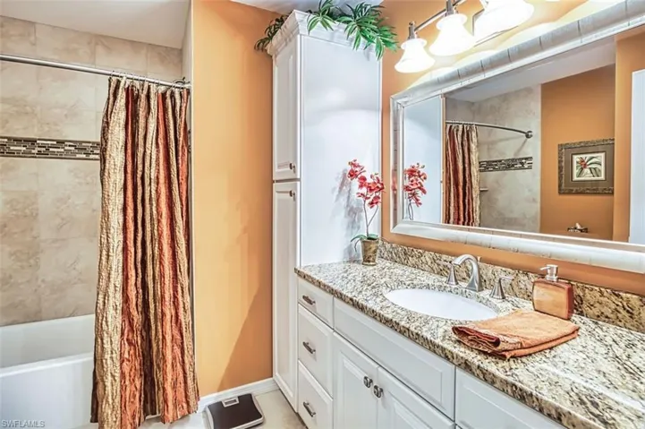 Full bathroom with vanity and shower / bathtub combination with curtain