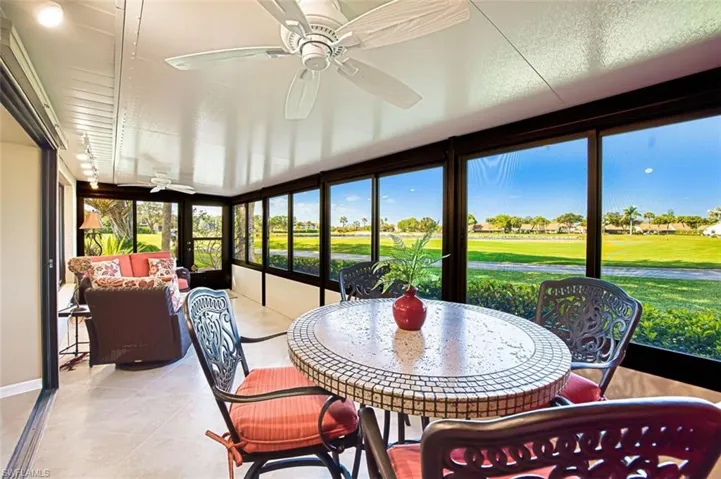 Sunroom / solarium featuring golf course view and tile patterned flooring