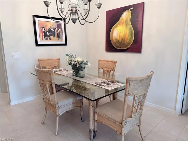 Dining room with hanging lights and baseboards