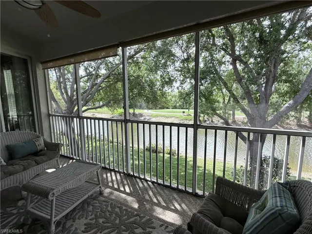 Lanai with a water view, and outdoor furniture