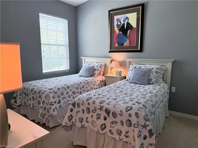 Carpeted bedroom featuring baseboards