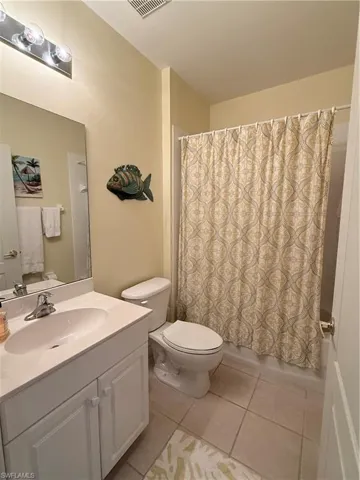 Full bathroom featuring vanity and light tile patterned flooring