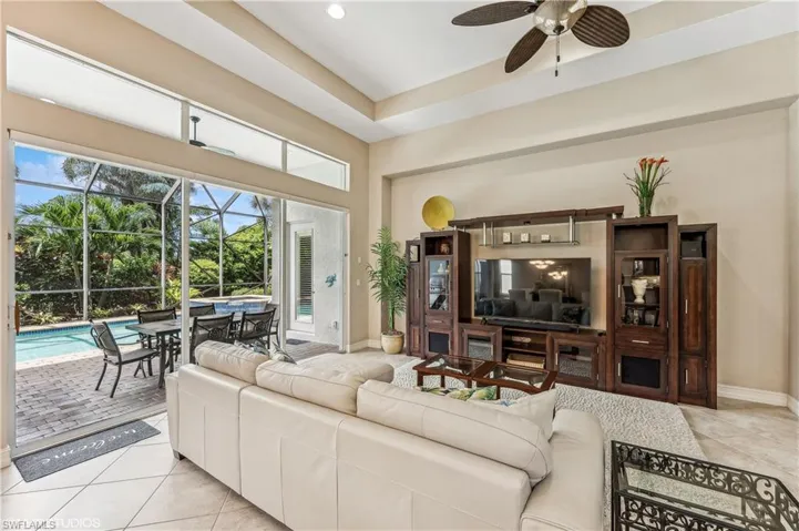 Living room featuring light tile patterned flooring and ceiling fan