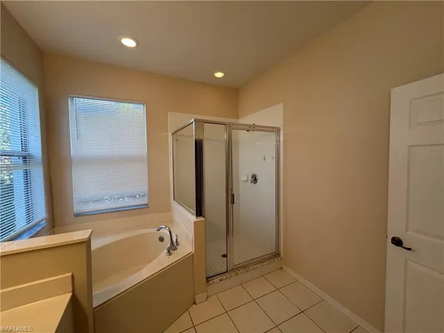 Full bath featuring a shower stall, a bath, light tile patterned floors, and recessed lighting