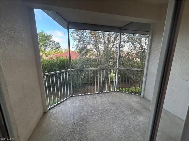 Unfurnished sunroom featuring a balcony