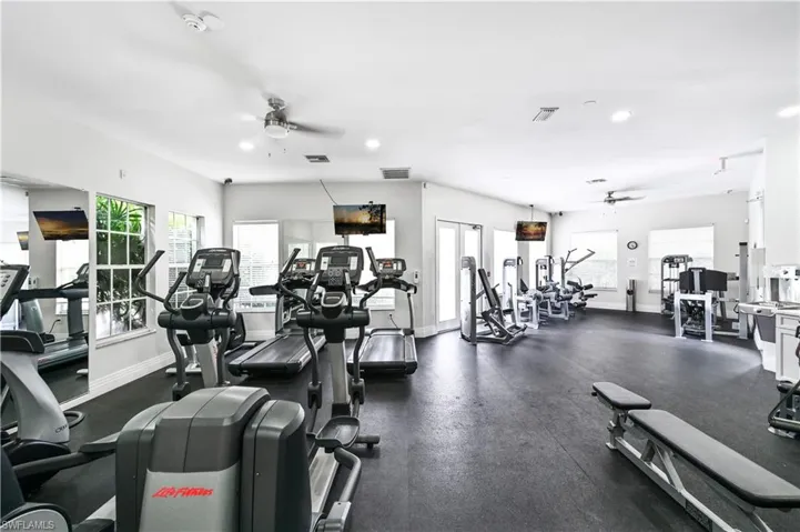 Exercise room featuring a ceiling fan and recessed lighting