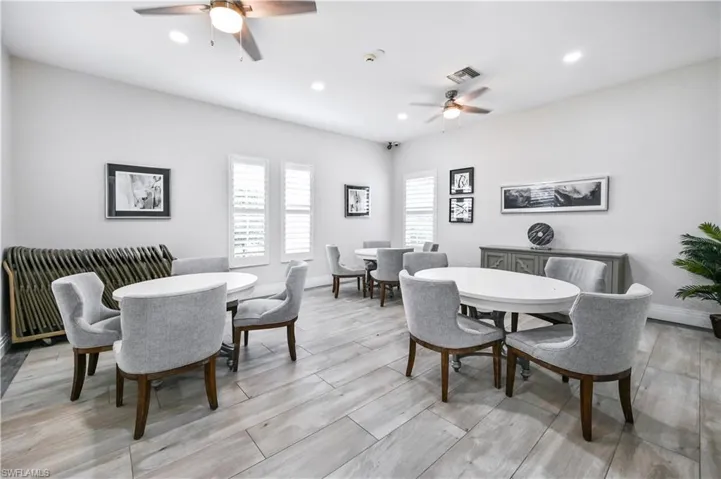 Dining room with ceiling fan, wood tiled floors, and recessed lighting