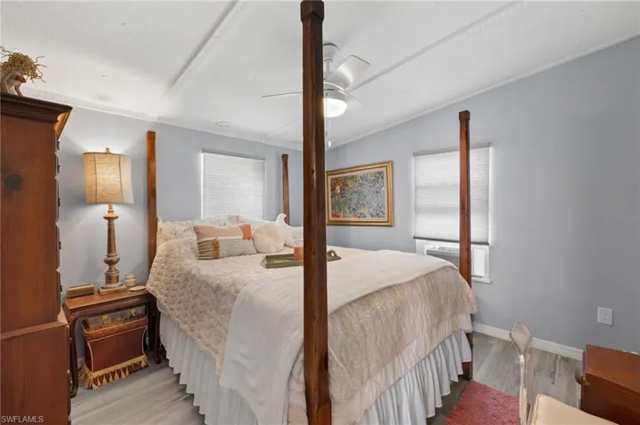 Bedroom featuring light hardwood / wood-style flooring, ceiling fan, and vaulted ceiling