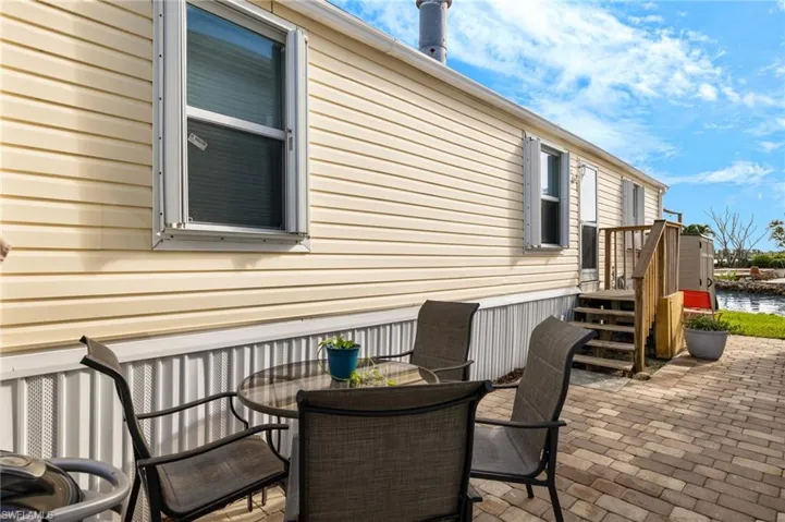 View of side of home with a patio