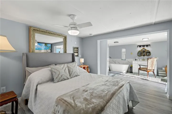 Bedroom featuring ceiling fan and hardwood / wood-style floors