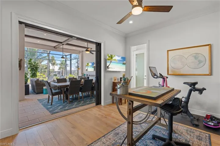 Office featuring hardwood / wood-style floors, ceiling fan, and ornamental molding