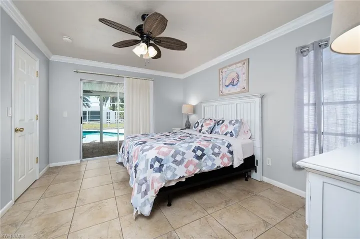 Bedroom with ornamental molding, access to exterior, ceiling fan, and light tile patterned floors