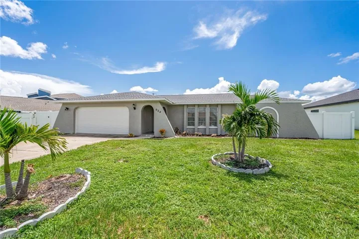 Ranch style home featuring stucco siding, an attached two car garage, and concrete driveway