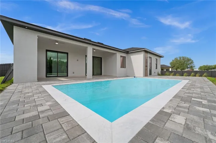 Rear view of property featuring a patio area and stucco siding
