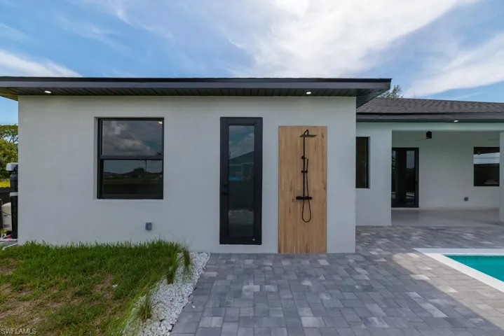 Rear view of property with stucco siding and a patio area