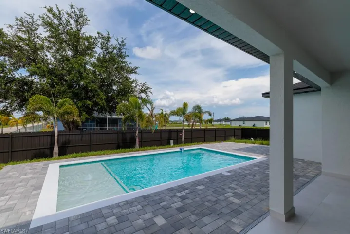 View of pool with a patio area and a fenced backyard