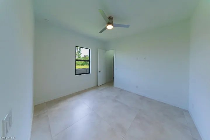 Unfurnished room with baseboards and ceiling fan