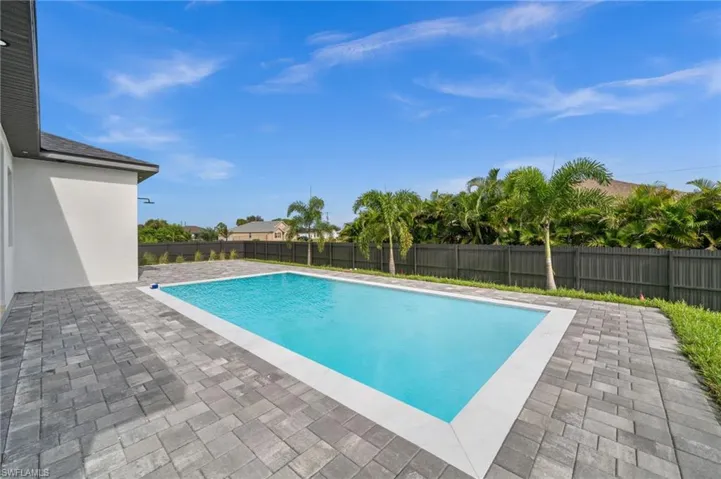 View of swimming pool with a patio area and a fenced backyard