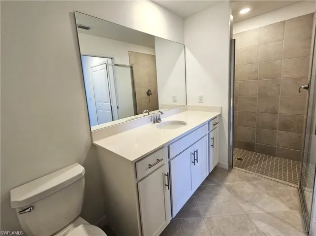 Bathroom featuring vanity, a stall shower, and recessed lighting
