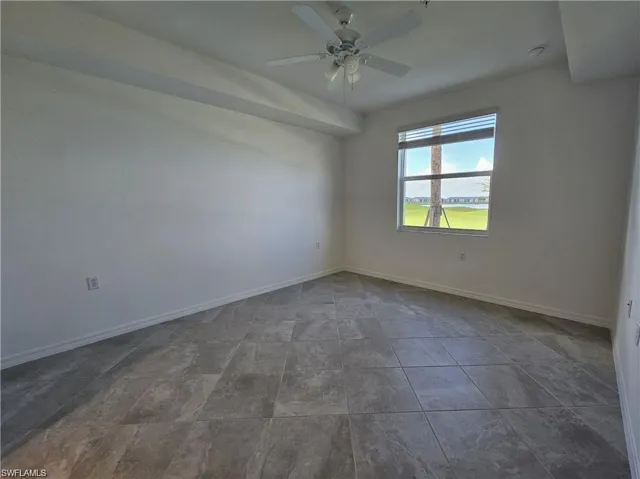 Spare room featuring baseboards and a ceiling fan