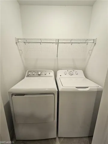 Laundry area with washer and clothes dryer