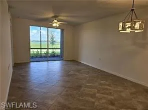 Unfurnished room with ceiling fan and suspended lighting