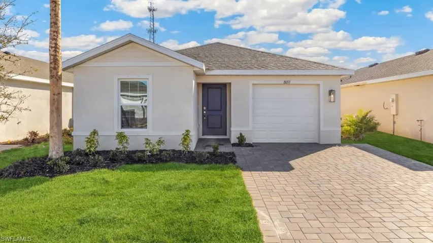 Model home. Single story home with a garage, decorative driveway, a front yard, and stucco siding