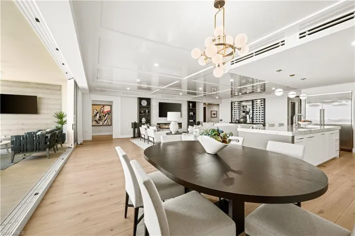 Dining room with light wood finished floors and a chandelier