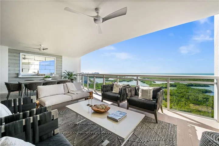 Balcony featuring ceiling fan, outdoor dining space, a water view, and an outdoor hangout area