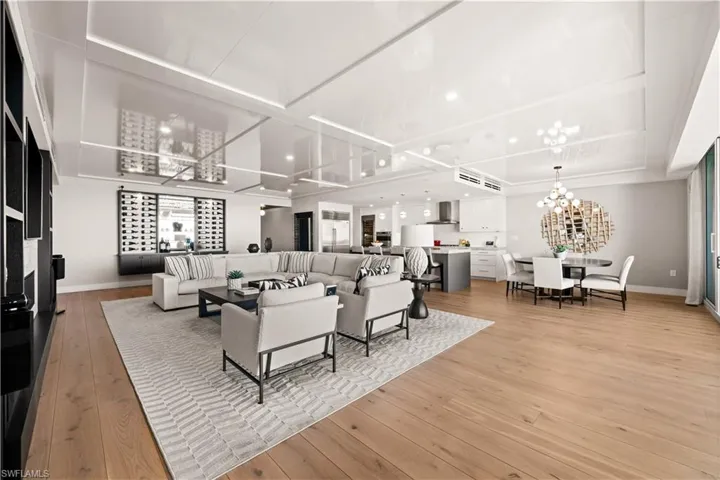 Living room with light wood-style floors and a chandelier