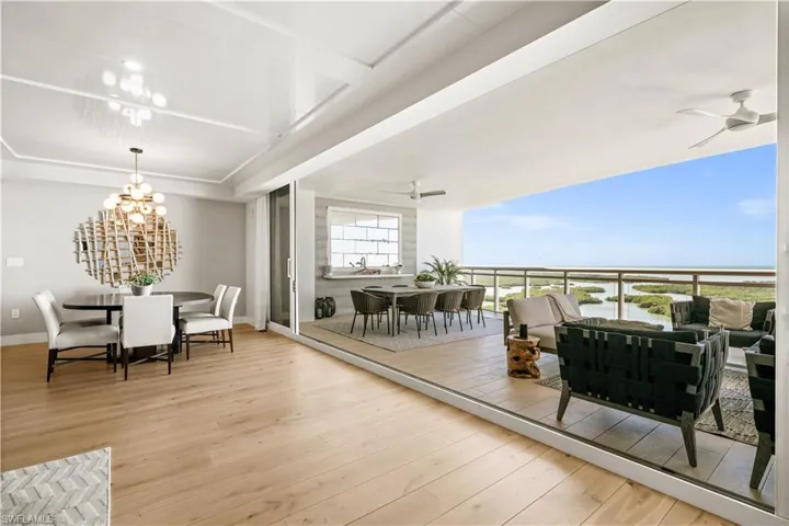 Dining room featuring light wood-type flooring, a ceiling fan, and a chandelier