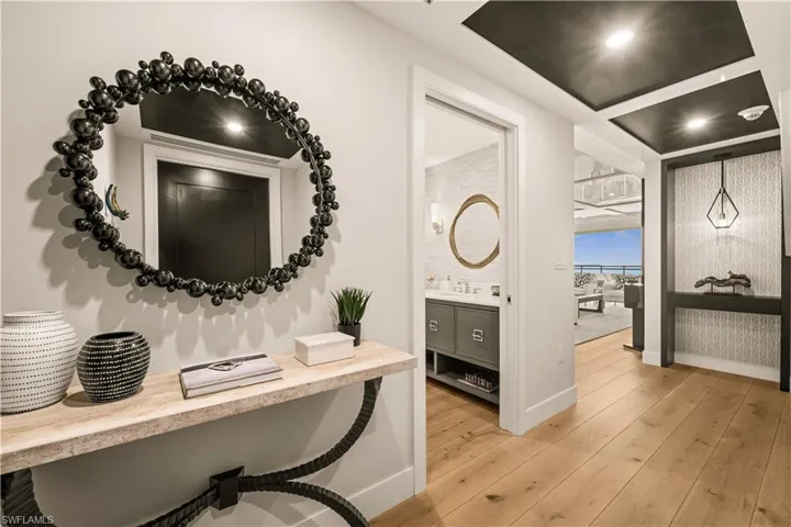 Corridor with light wood-style flooring and recessed lighting