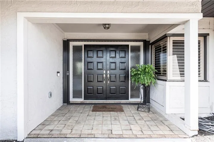 Entrance to property featuring stucco siding