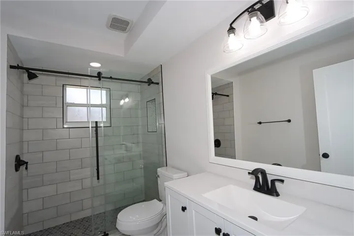 Full bath featuring vanity and a shower stall