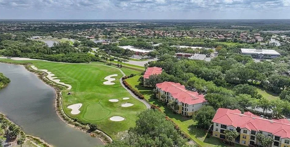 Aerial view featuring a water view and view of golf course