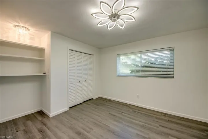 Unfurnished bedroom featuring wood finished floors and a closet