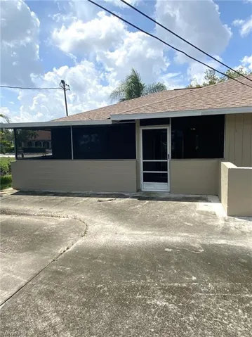 View of rear exterior of house and large open patio.