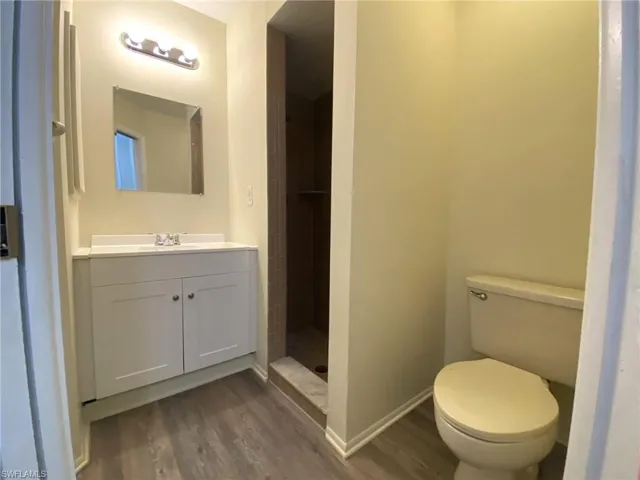 Guest bathroom with tiled walk in shower and new vanity, lighting and LVP flooring