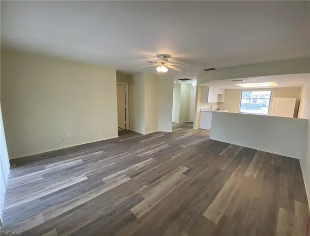 Livingroom view to Kitchen and Master bedroom on left. New LVP flooring