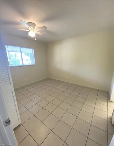 Master bedroom with tile flooring and ceiling fan